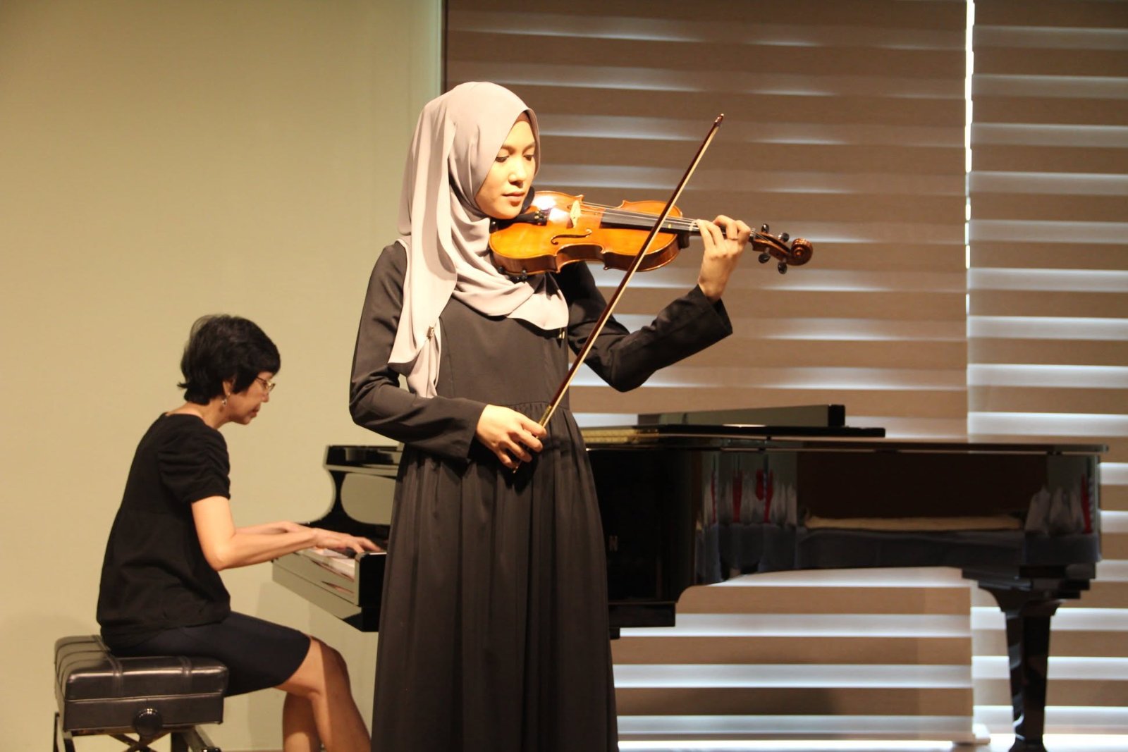Violinist performing with piano accompaniment at Cephas Music School