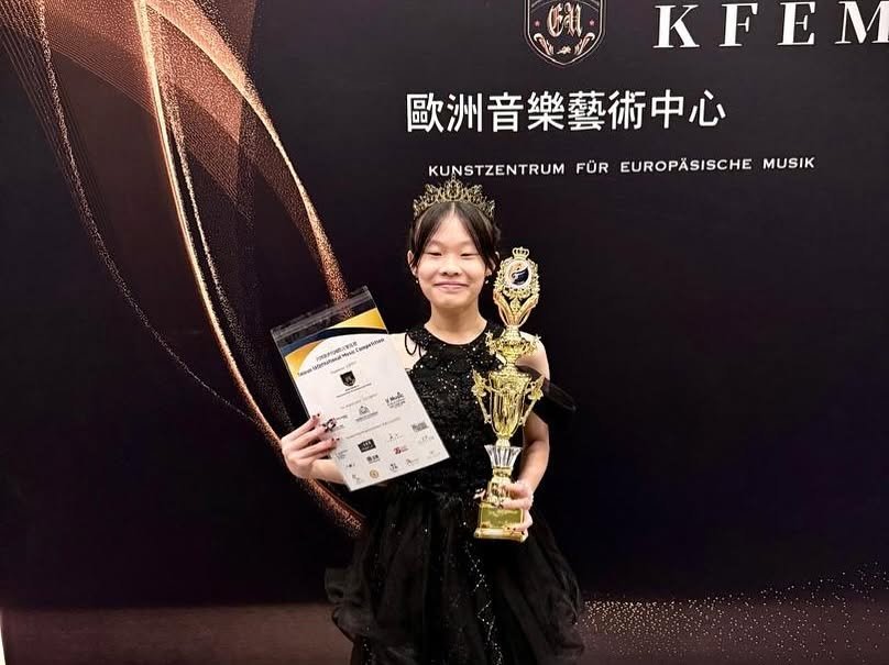 Cephas student with her trophy and certificate from an international competition