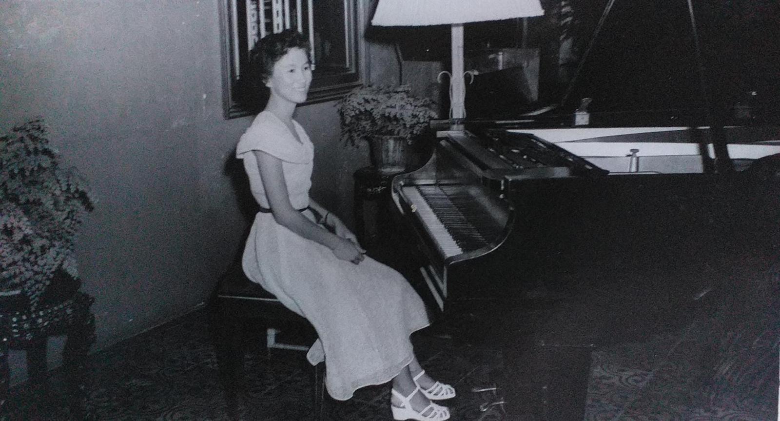 Mdm. Karminia Bongsu seated at the piano